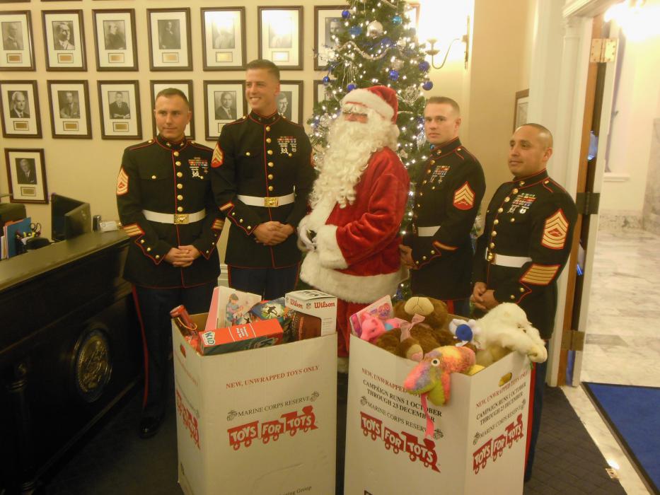 U.S. Marine Corps members from Bridgeport, CA, pose with Santa Claus and full donation bins