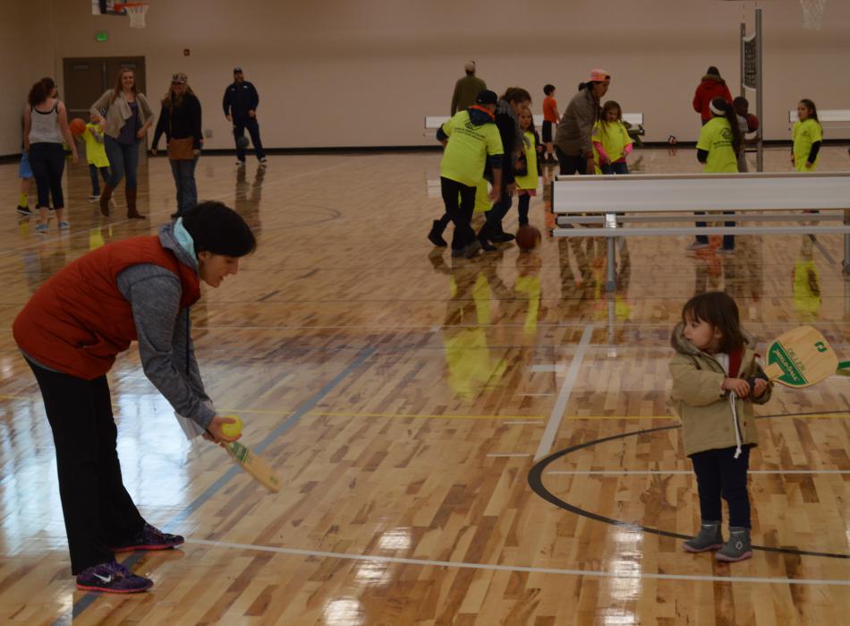 A future pickle ball player gets her first lesson on the main floor of the MAC.