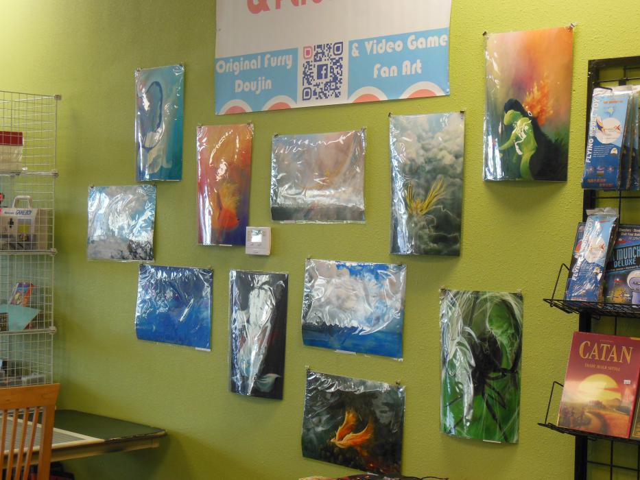 Display of local artist works on one wall of the Nerdvana store.