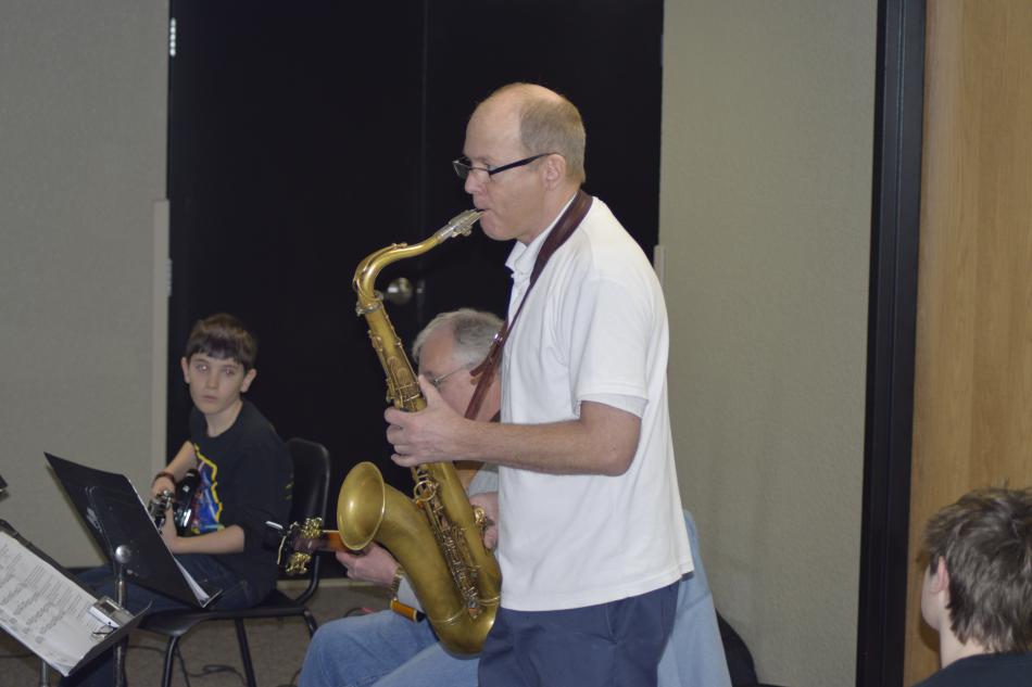 Mr. Kline plays a blues riff for students
