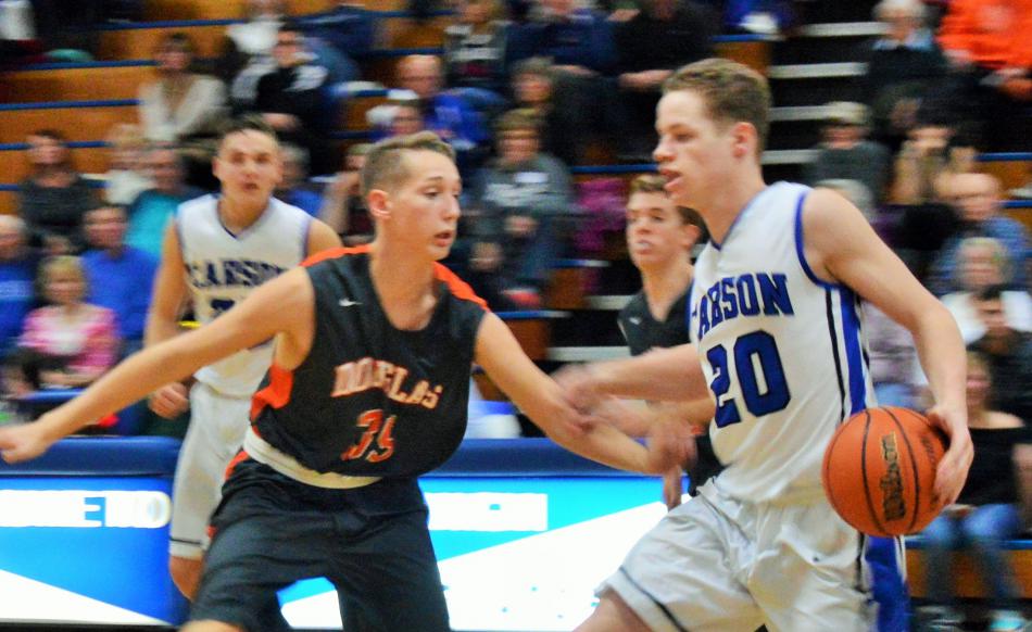 Tez Allen (20) drives against a Douglas opponent Tuesday night at Carson High School.
