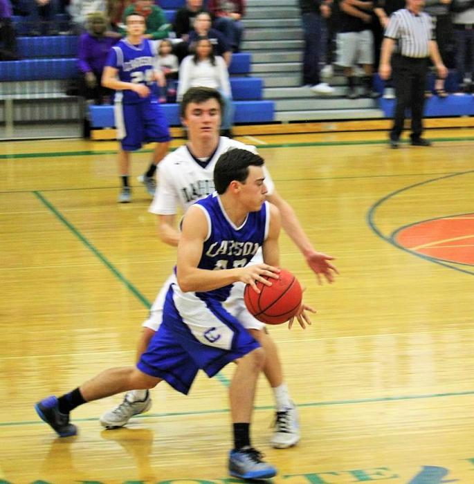 Cody Azevedo drives against a Damonte Ranch defender Friday night. Photo courtesy Jenn Minifie.