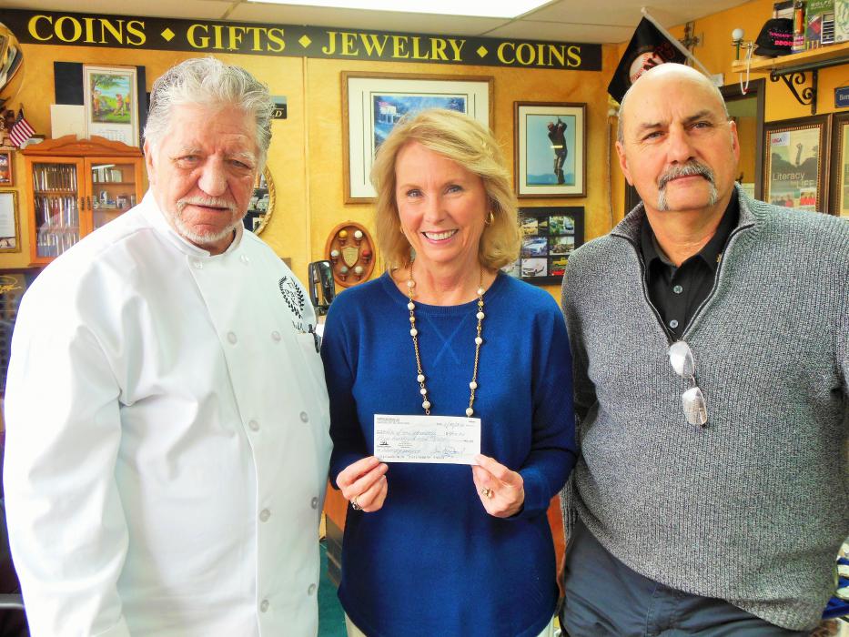 Chef Don Pepe (left) presents a donation check to