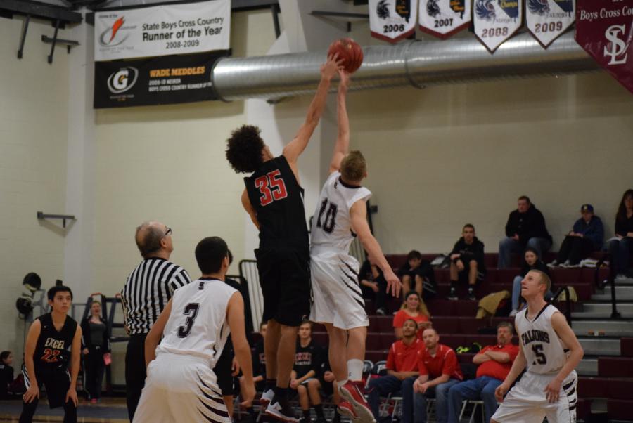 Freshman Zane Warkentin snatches the ball away from an Excel Christian player.