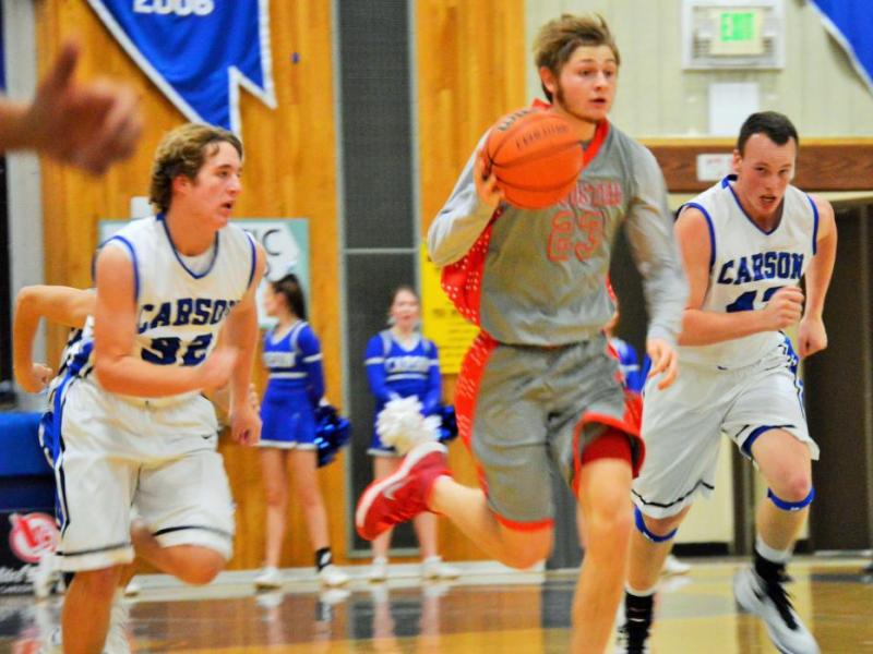 Kyle Krebs (32) and Ian Schulz (42) chase down a Wooster player Tuesday night at Carson High School.