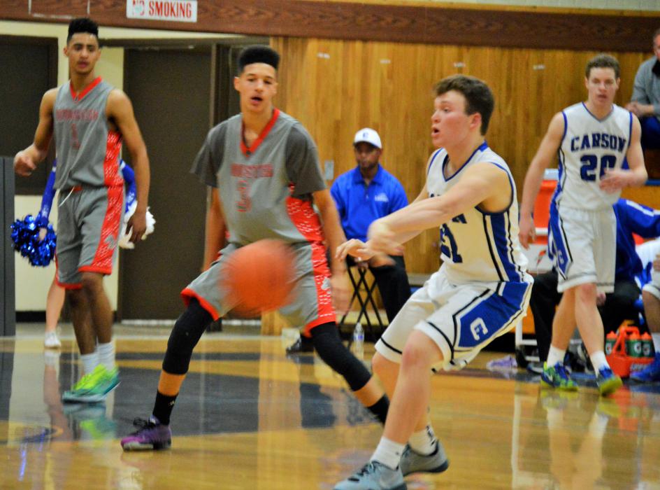 Jace Keema (21) passes the ball to a teammate Tuesday night at home against Wooster.