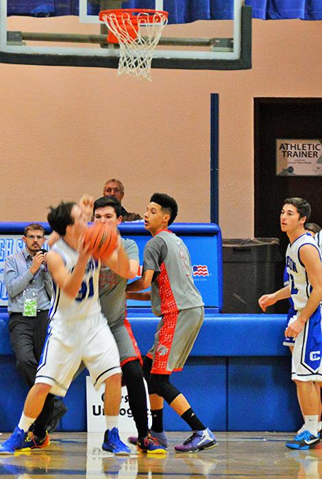 Connor Quilling (31 with ball) shoots against Colts defenders Tuesday night at CHS.