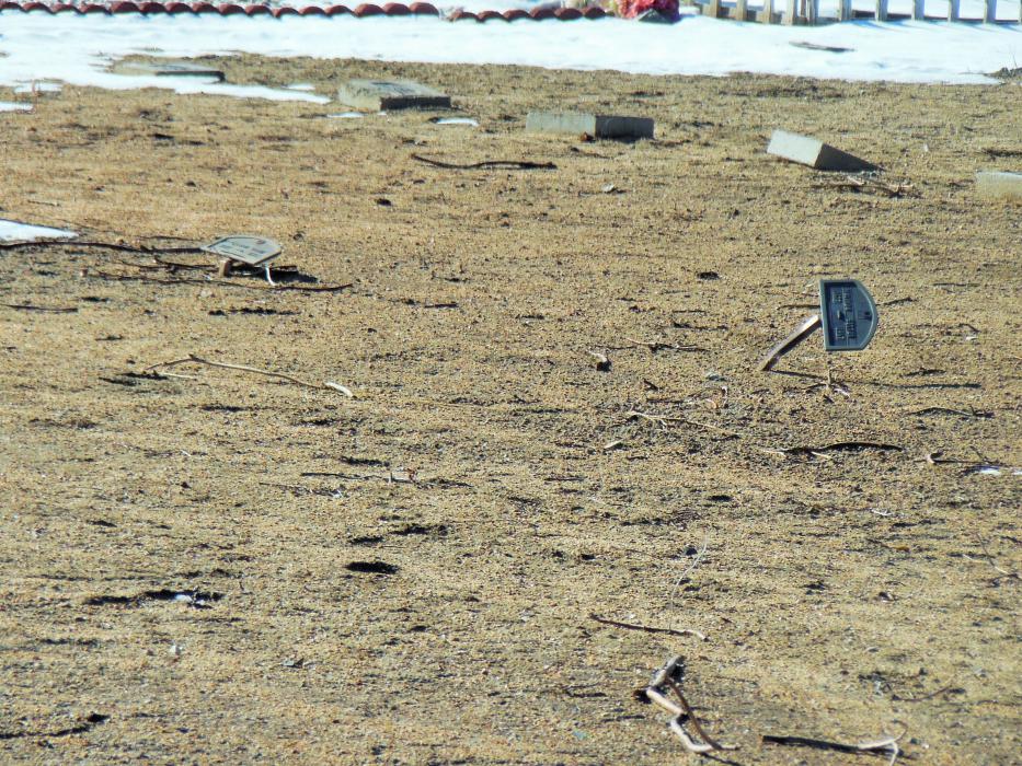 Temporary tin markers that have been twisted and bent at Lone Mountain Cemetery.