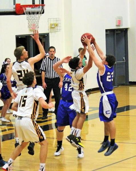 Photo courtesy Jenn Minifie, CHS. Cody Azevedo (23) battles a Galena player for a rebound Friday night in Reno.