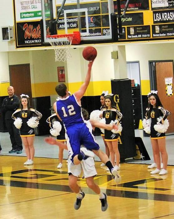 Photo courtesy Jenn Minifie, CHS. Asa Carter goes in for a lay up against a Grizzly defender Friday night at Galena High School.