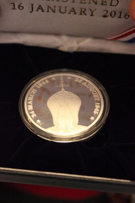 The side of the commemorative medallion depicting the USS CARSON CITY