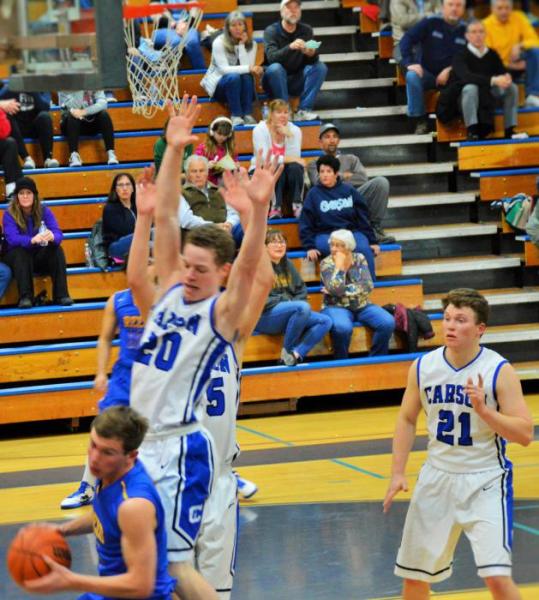 Tez Allen (20) and Jayden DeJoseph double team a Reed player under the basket Wednesday night at Carson High School.