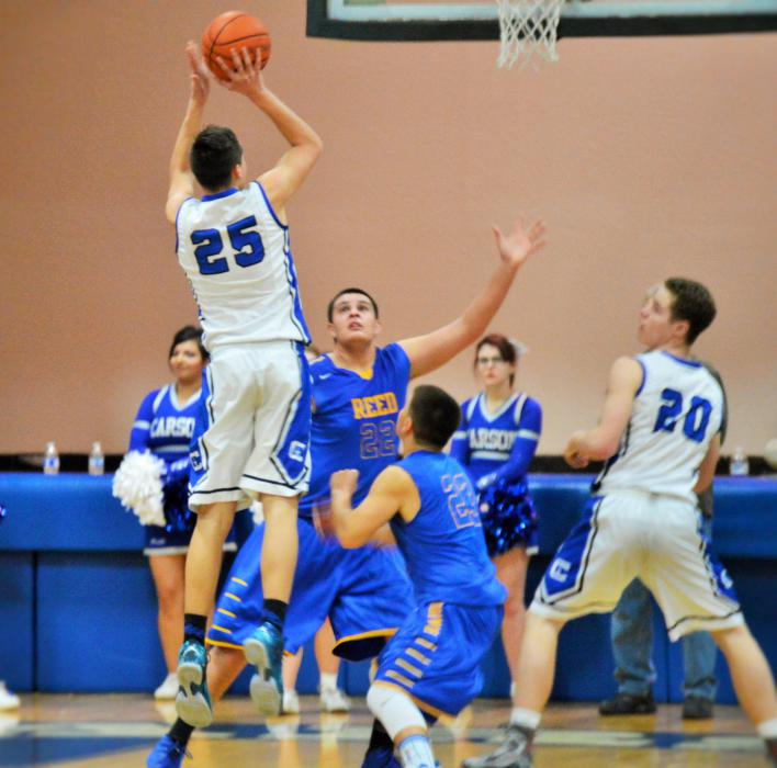 Jayden DeJoseph (25) takes a jump shot over the Reed defense Wednesday night at CHS.