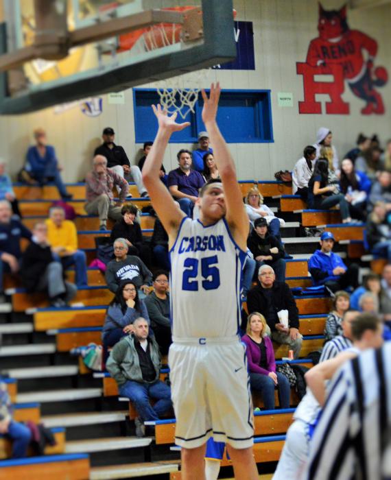 Jayden DeJoseph grabs a defensive rebound Wednesday night against Reed High.