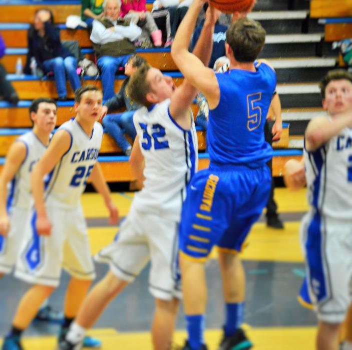 Kyle Krebs (32) goes up to block a shot against Reed High Wednesday night at CHS.