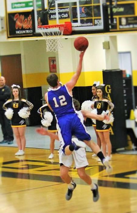 Photo courtesy Jenn Minifie, CHS. Asa Carter drives to lay up against a Galena defender in a game earlier this month.