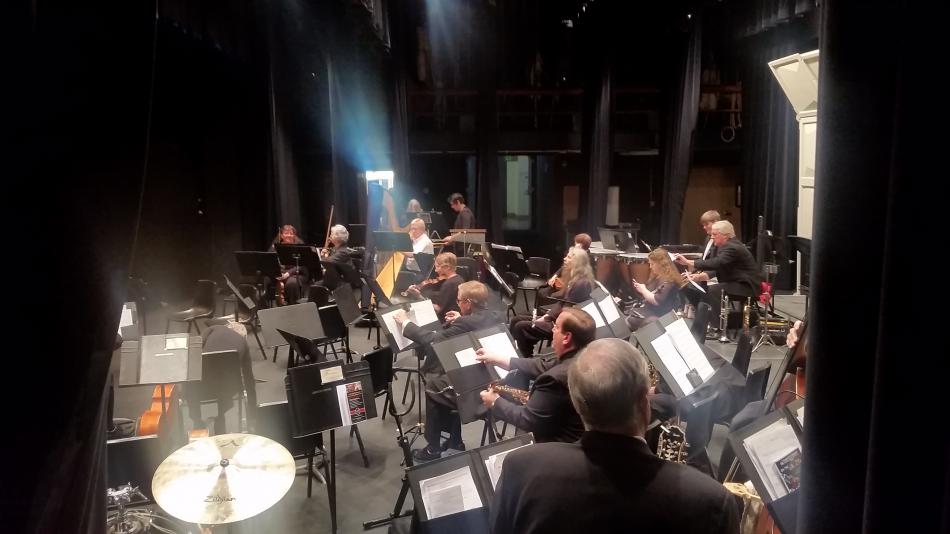 Symphony members warm up backstage