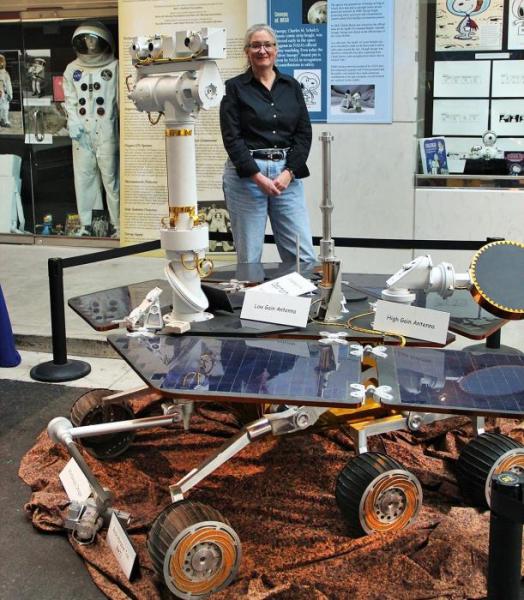 Photo courtesy UNR. Wendy Calvin poses with a Mars rover replica at the National Automobile Museum in Reno.