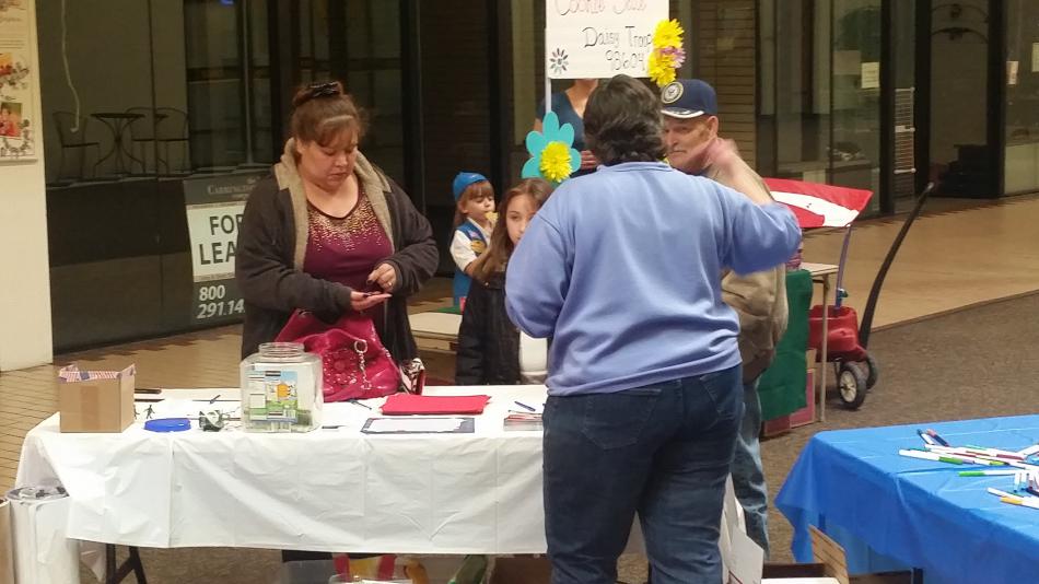 Volunteer helps explain how to fill boxes for soldiers