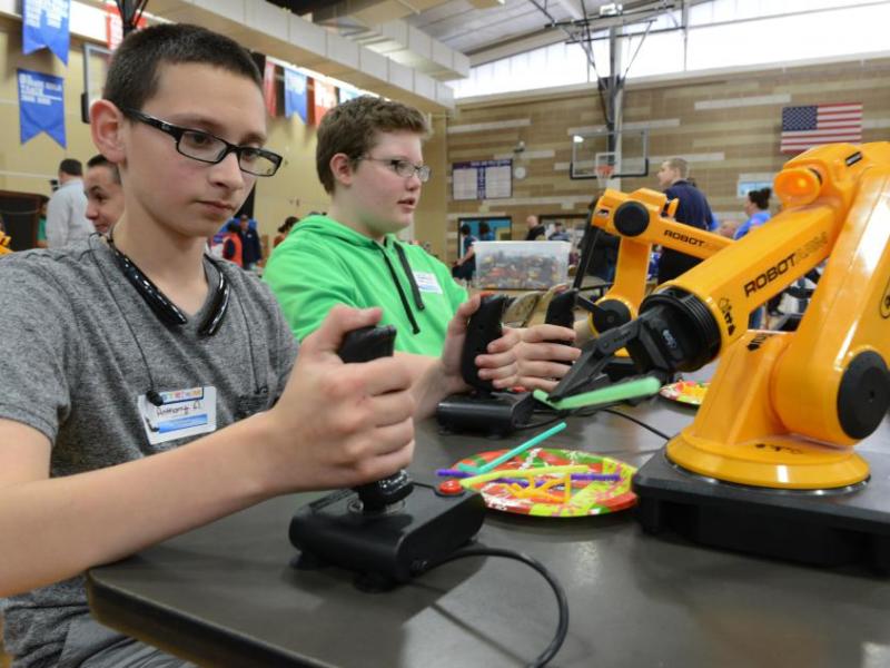Anthony Aguilar, left, and Jack Wilson work with robotic arms at Eagle Valley's STEM Night. Photo by Tim Dunn