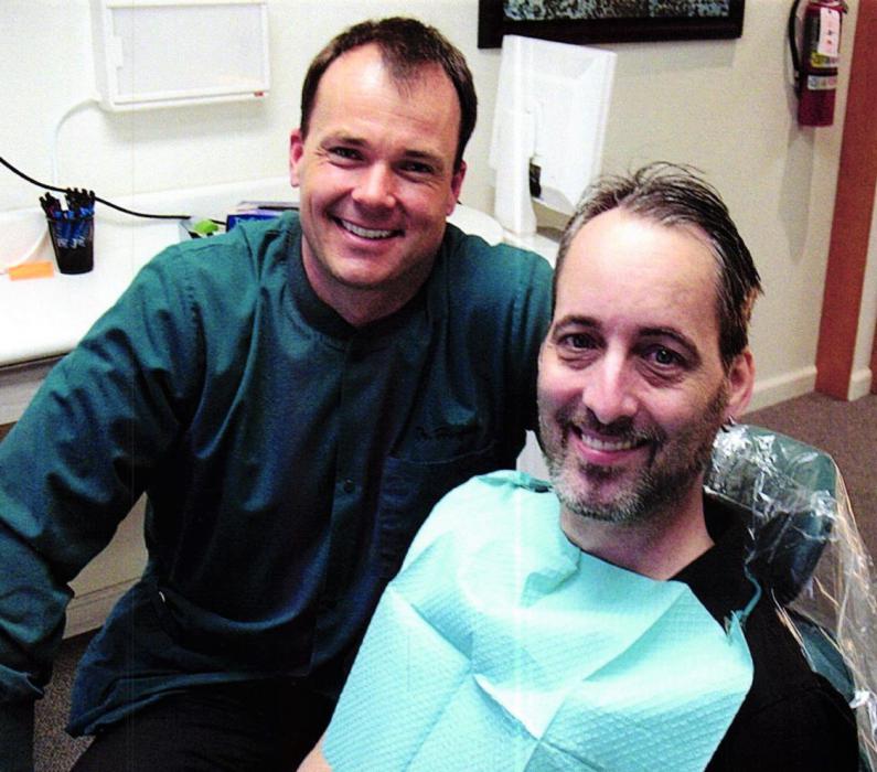 Photo courtesy AAVDP. U.S. Marine Veteran Ken Collins (right) with his dentist, Dr. Ben Horgan.