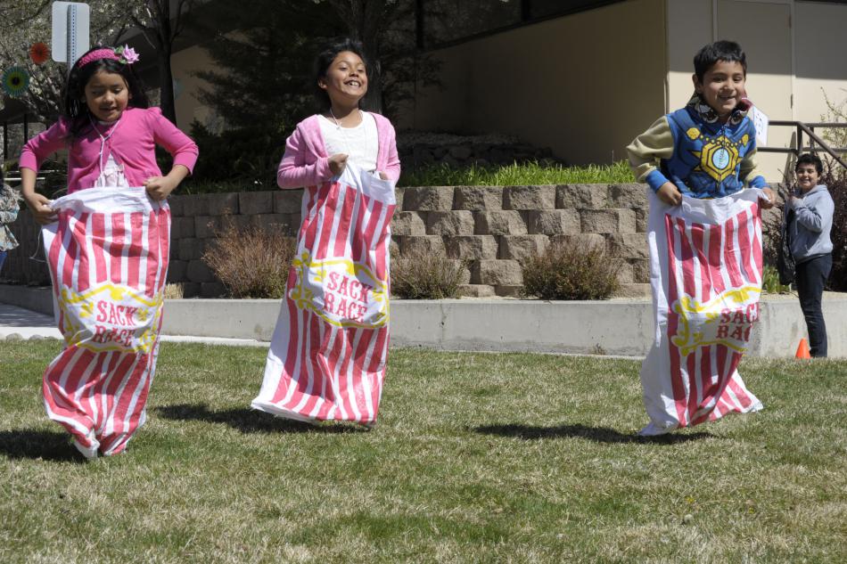 Alondra Pierrott, 7, left, Kimberly Herrera, 8, and Isaac Ledezma, 6, all of Carson City, take part in a sack race.