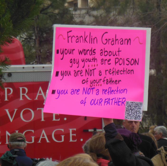 An event protester displays a sign at Wednesday's Decision America rally.
