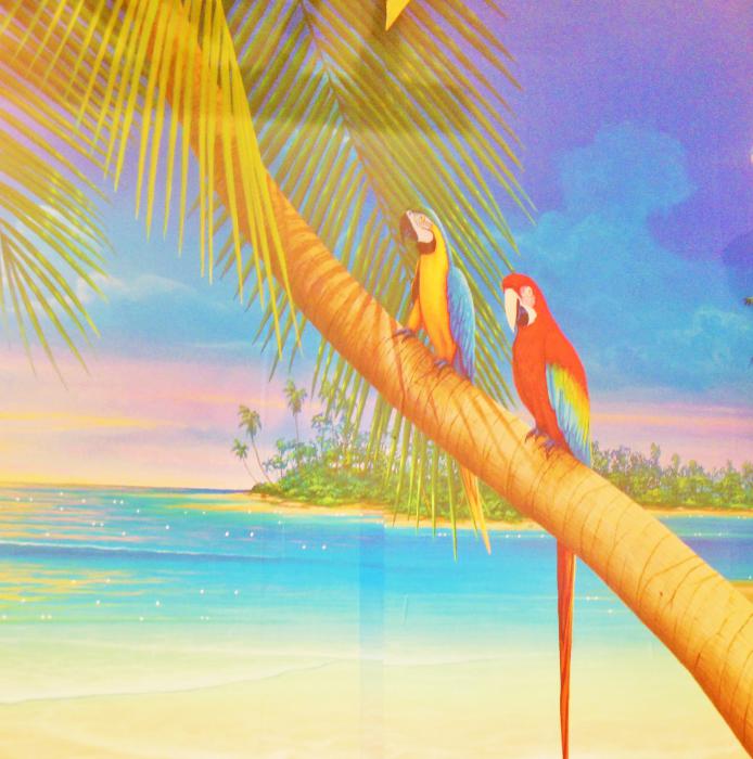 A tropical mural that takes up an entire wall inside Mom & Pop's Diner.