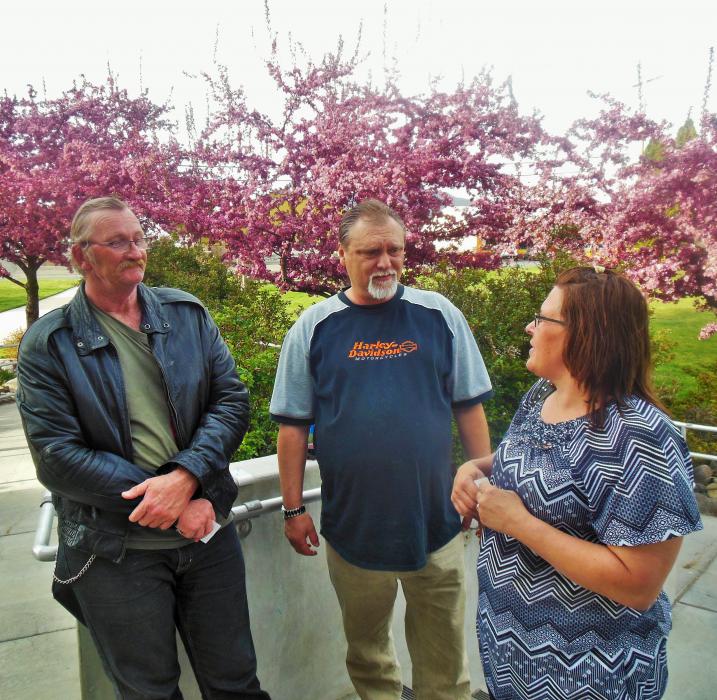 RCIL clients Thomas Kraft (left), Dean and Angie Baird gather outside the Community Center Thursday evening.