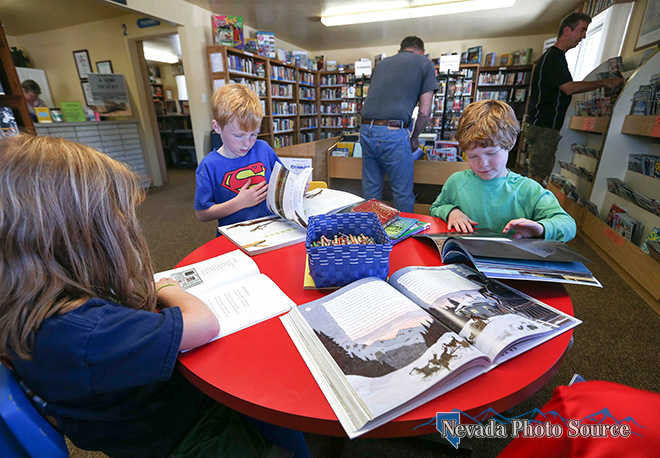 Lillian Barker, 7, Rafe Harvey, 6, and Elizabeth Barker, 7, read children’s books. Cathleen Allison, Nevada Photo Source