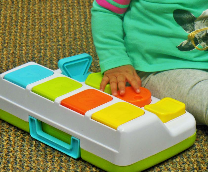 An infant plays on the floor in a visitation room at the DCFS office in Carson City.