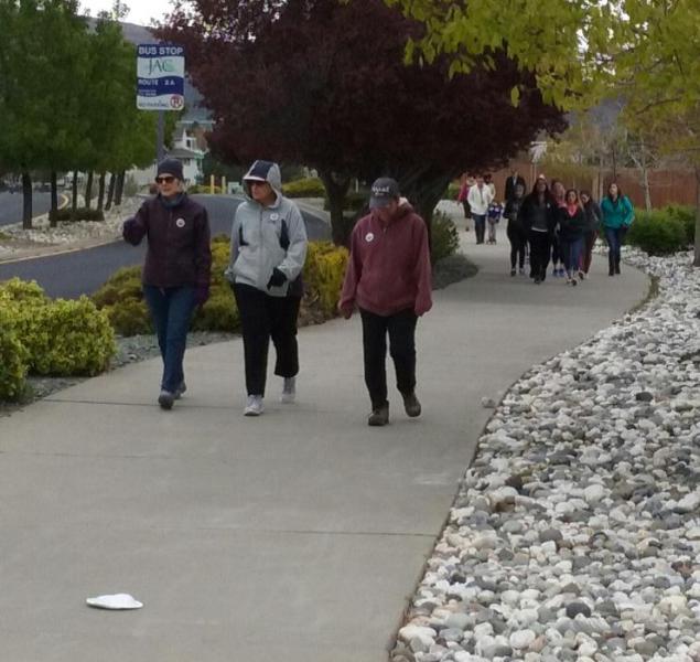 Walkers make their way up College Parkway Saturday morning.
