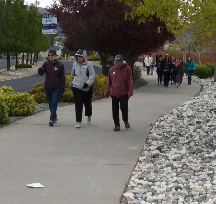 Walkers make their way up College Parkway Saturday morning.
