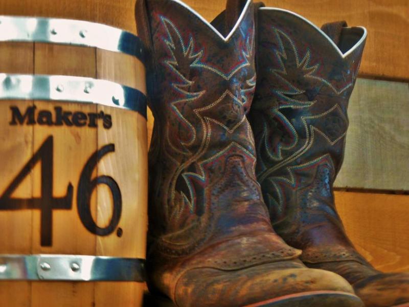 Cowboy boots and a whiskey barrel at Cowboys Liquor.