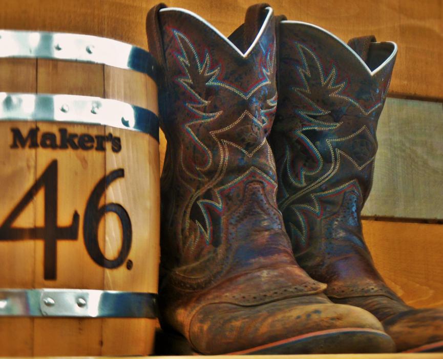 Cowboy boots and a whiskey barrel at Cowboys Liquor.