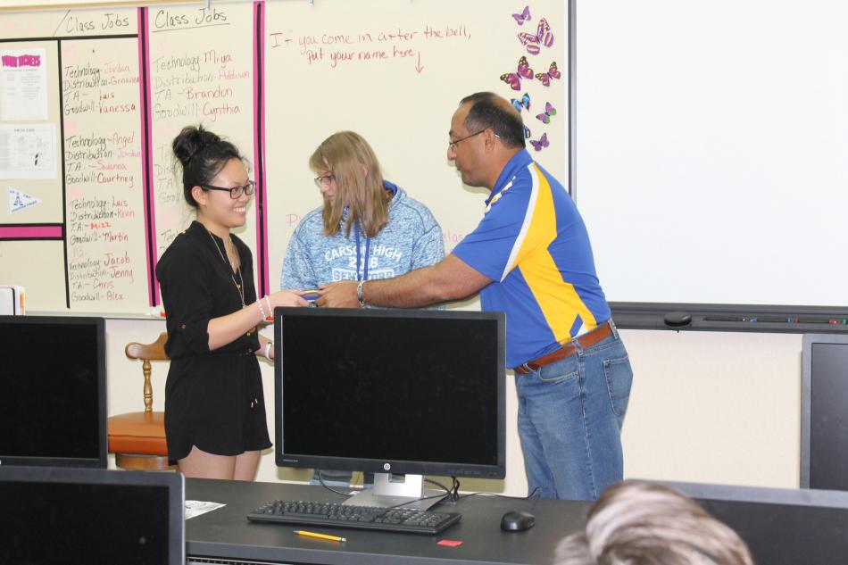 Amanda Yau and Stella Carroll, Carson High CTE graphic design students, receive awards from WNC soccer program.