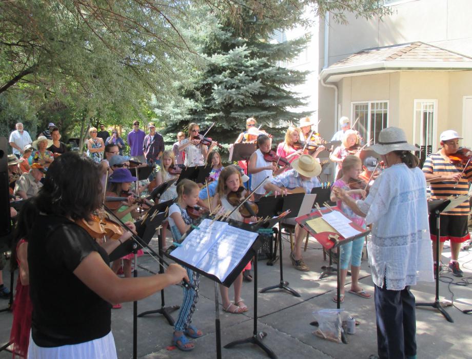 Sue Jesch leads Strings in the Summer participants of all ages in performance last July at Sierra Place.