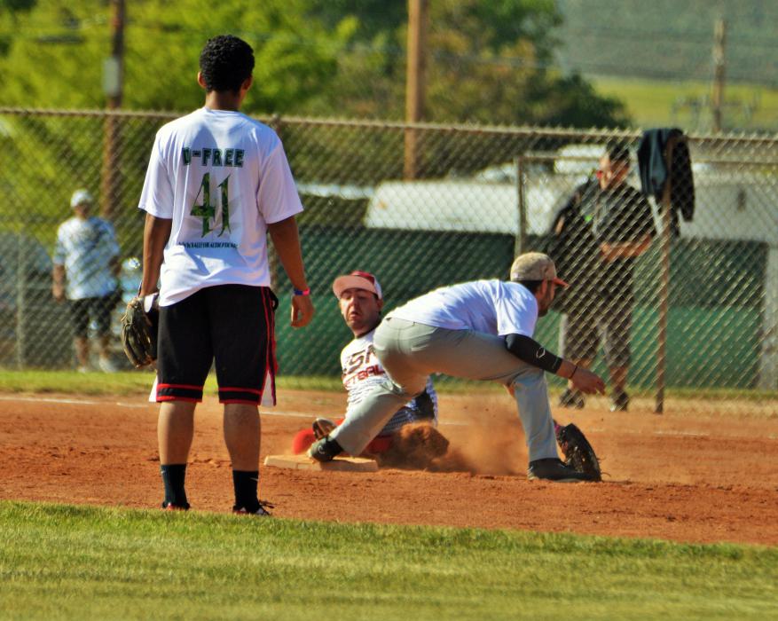 A base runner slides into second ahead of the tag Saturday morning at Centennial Park.