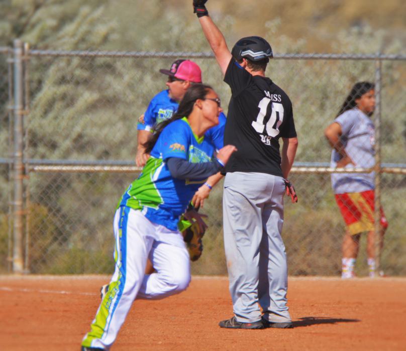 Runners advance on a base hit into the outfield Saturday morning at Centennial Park.