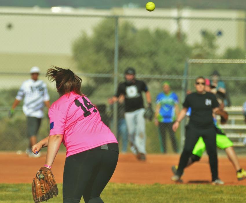 An outfielder throws to third base Saturday morning at Centennial Park.