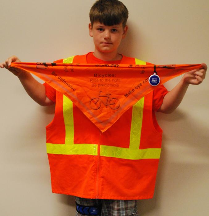 Ripley Hitch, 9, shows a reflective vest. Photo courtesy of CCSO.