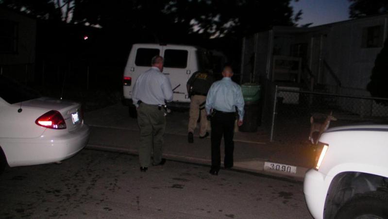 Carson City sheriff's investigators outside the Melanie Lane home Thursday night.