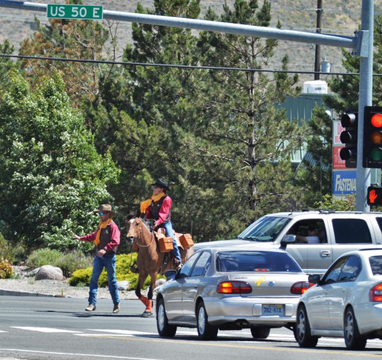 Photo by Lisa Fisher. Traffic is halted briefly for Anne Martins and Rosie to cross Highway 50 at Arrowhead.