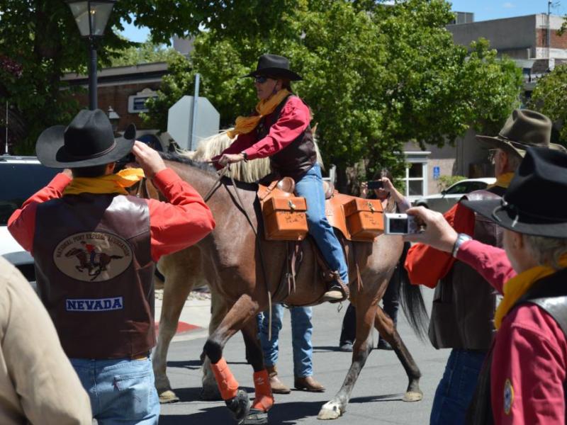 Photo by Lisa Fisher. Anne Martins on her Shoshone mustang Rosie take off with the Mochila from Eagle Mountain Trading Post.