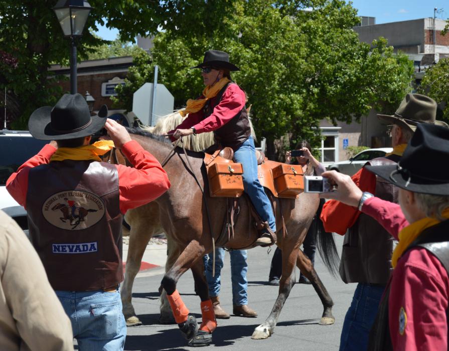 Photo by Lisa Fisher. Anne Martins on her Shoshone mustang Rosie take off with the Mochila from Eagle Mountain Trading Post.