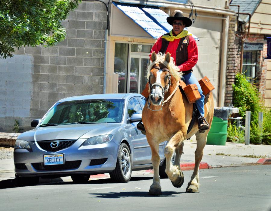 Photo by Lisa Fisher. A rider trots through downtown Carson City for the exchange at Second and Curry streets.