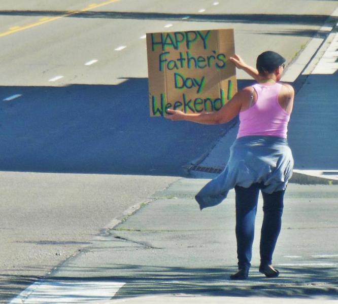 Carson City resident E.D. with a Father's Day sign Friday afternoon next to Slot World.