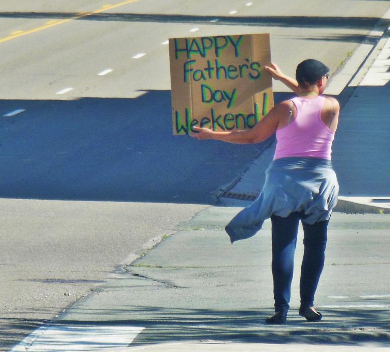 Carson City resident E.D. with a Father's Day sign Friday afternoon next to Slot World.