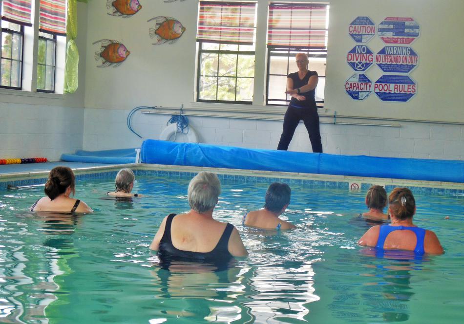 Starr Nixdorf (center poolside) leads an Ai Chi class at Paradise Wellness Spa.