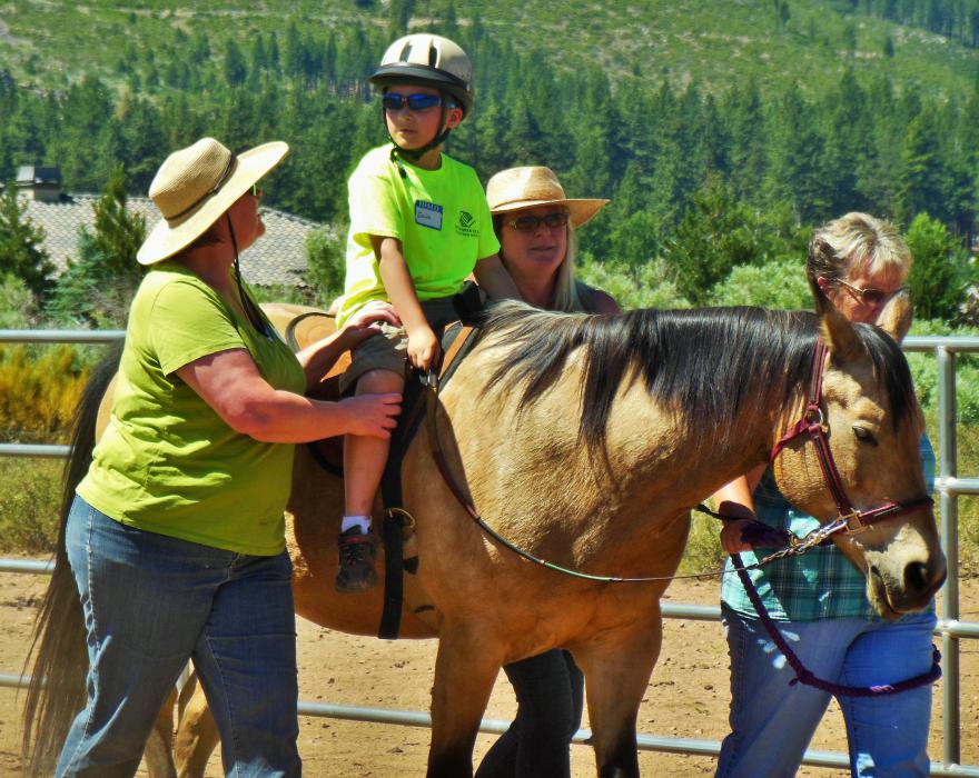 Isaiah and Spirit walk with their therapy team.